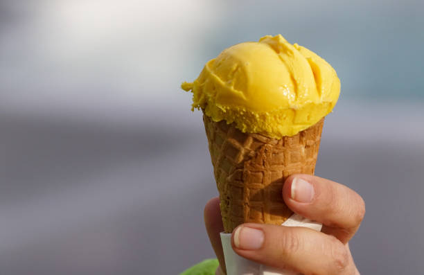 istock A cropped hand holding ice cream cone 1455997266