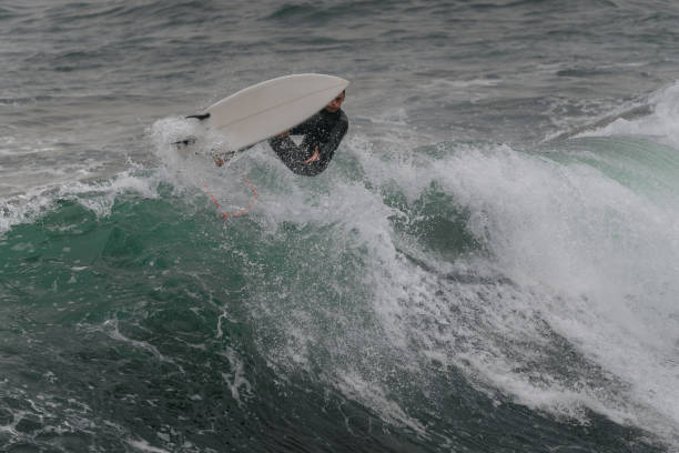 istock movement 5 young man surfs a wave  in Telde. Gran Canaria. Canary Islands 1455997828