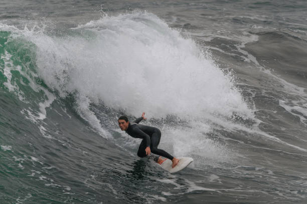 istock movement 1 young man surfs a wave  in Telde. Gran Canaria. Canary Islands 1455997830
