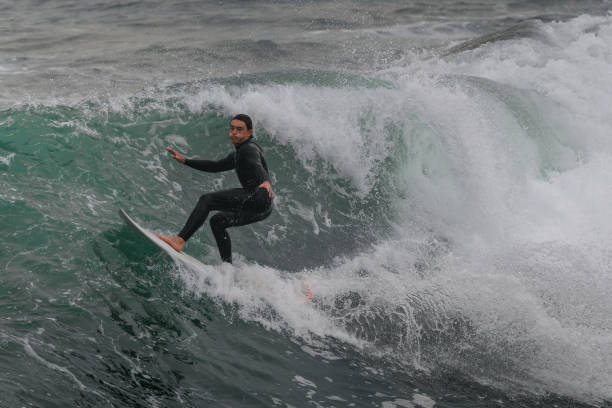 istock movement 3 young man surfs a wave  in Telde. Gran Canaria. Canary Islands 1455997831