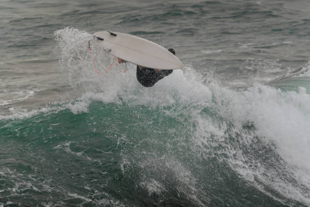 istock movement 6 young man surfs a wave  in Telde. Gran Canaria. Canary Islands 1455997842