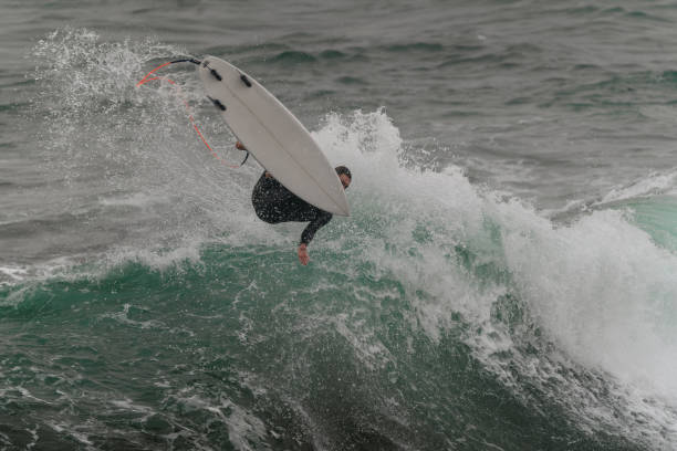 istock movement 7 young man surfs a wave  in Telde. Gran Canaria. Canary Islands 1455997846