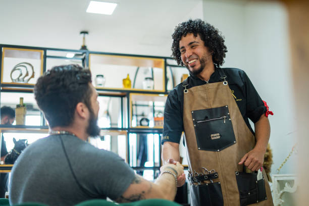 istock male stylist performs haircut to a client 1455998552
