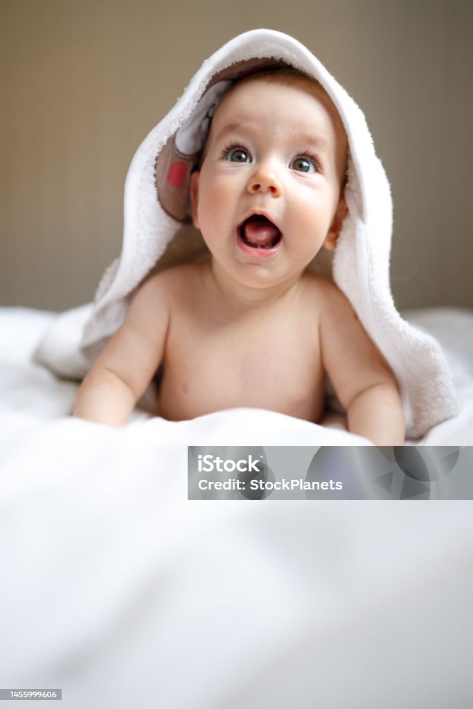 Baby wearing towel after bath Cute baby wearing towel after bath at home Baby - Human Age Stock Photo