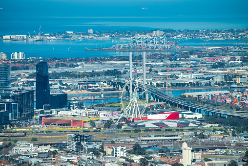 Aerial view of Melbourne skyline and Ferris Wheel from helicopter on a beautiful sunny day, Australia
