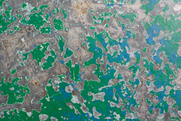 istock Closeup of an emerald peeling paint on a concrete wall background 1456002769