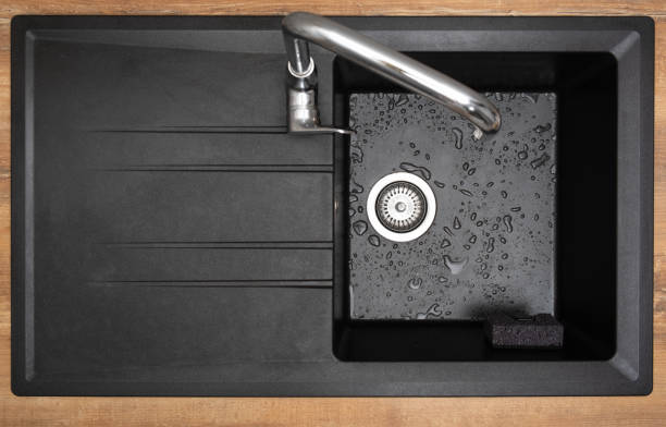 New clean granite kitchen sink black, holder for kitchen sponge. After. Drops water. Top view