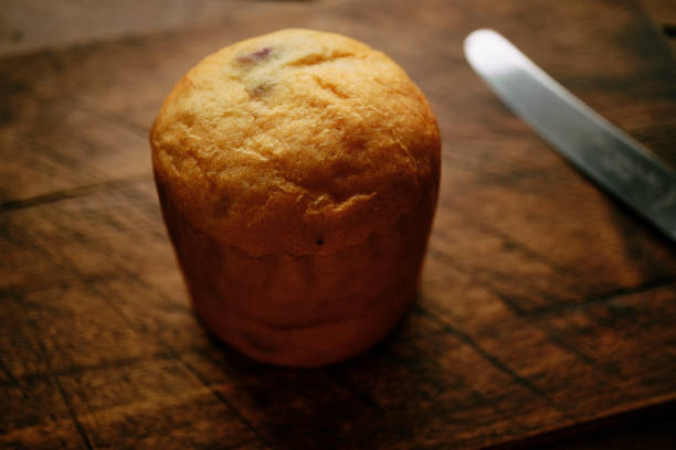Panettone on an aged wooded chopping board.