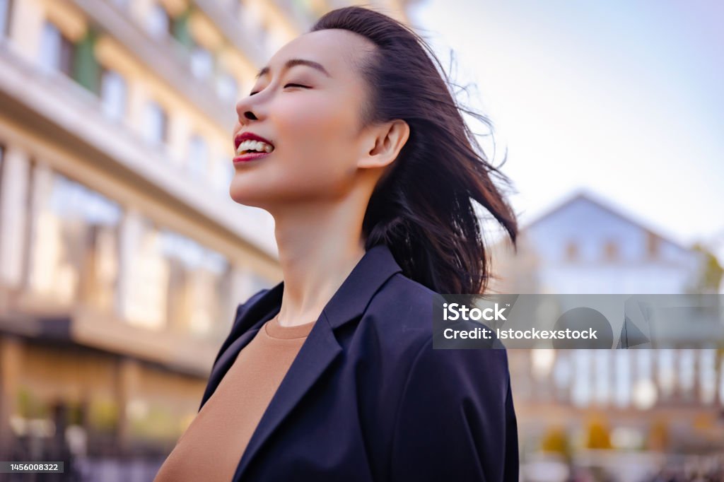 Successful female manager standing on the city street. Leaving Stock Photo
