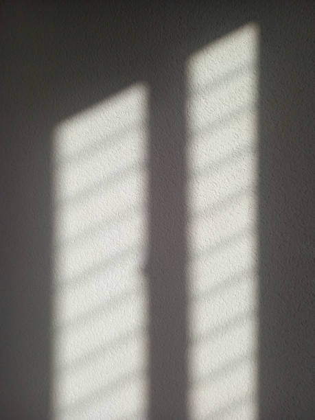 istock Background of white shadow from window on white wall. Abstract. Light shadow on rough wall. Shadow on background. 1456008620