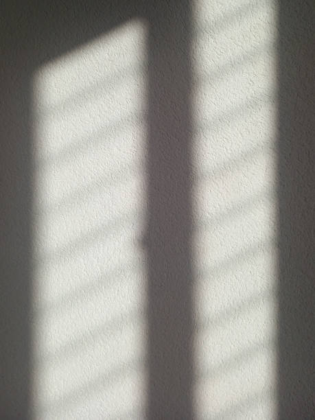 istock Background of white shadow from window on white wall. Abstract. Light shadow on rough wall. Shadow on background. 1456008628