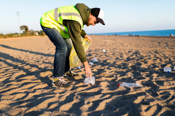 istock Volunteer taking out garbage from the beach 1456009544