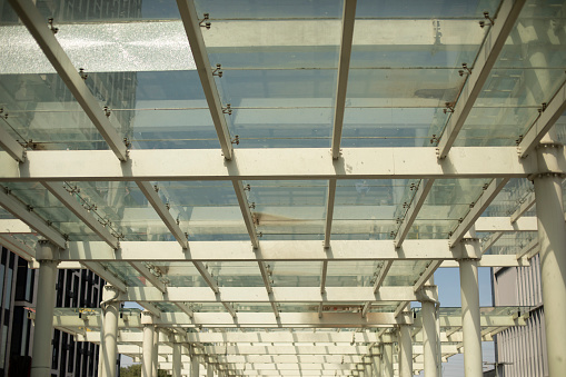 Glass ceiling. Transparent roof. Details of modern station. Steelwork. Glass architecture.