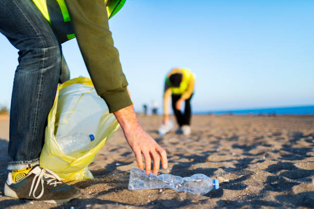 istock Two volunteers taking out garbage from the beach 1456010622