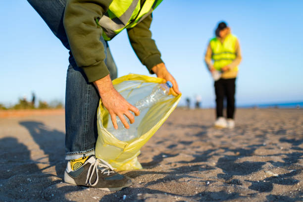 istock Two volunteers taking out garbage from the beach 1456010726