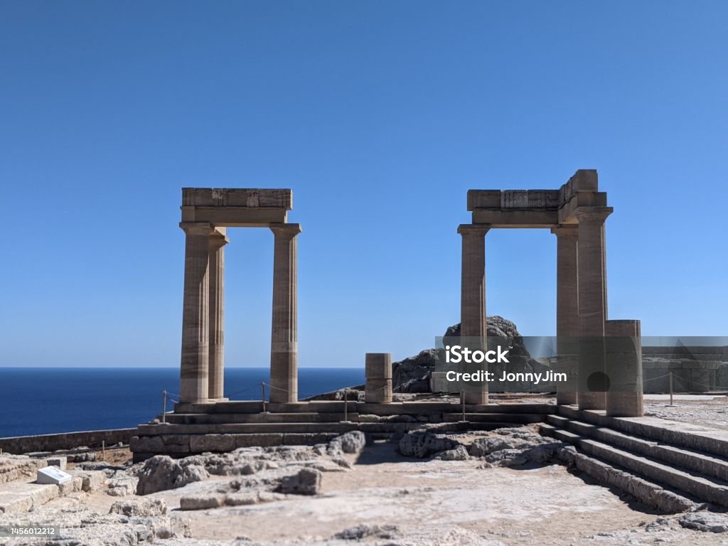The Acropolis, Lindos , Rhodes Greece An old ruined Greek structure that was once a temple with typical columns Acropolis - Lindos Stock Photo