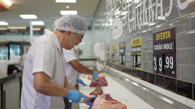 Butcher cutting meat in a butcher's shop