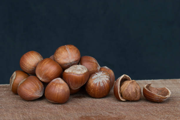 istock Fresh hazelnuts on wood. Shelled and broken. 1456014544