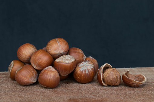 Fresh hazelnuts on wood. Shelled and broken.