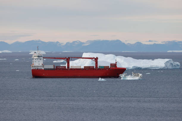 istock small boats sailing near big icebergs 1456016371