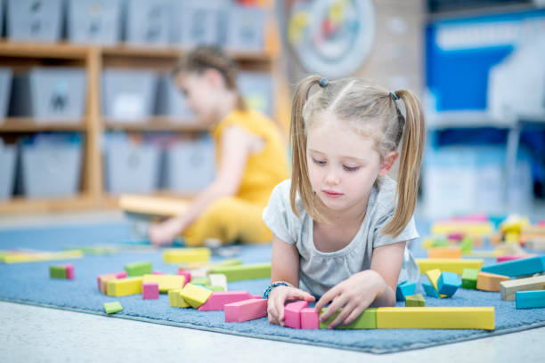 istock Little Girl Playing with Blocks 1456017235