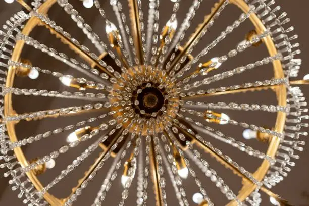 A low-angle shot of a vintage-style chandelier with decorative diamonds