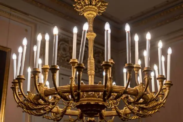 A close-up shot of a vintage-style chandelier with decorative candles