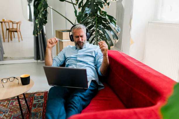 istock Senior man having video call and working at home 1456018322