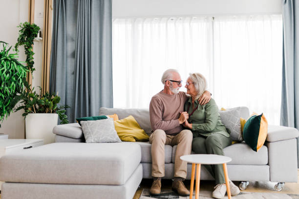 istock Old senior retired couple enjoy talking conversation together on sofa with happiness laugh smile and joyful at home 1456018743