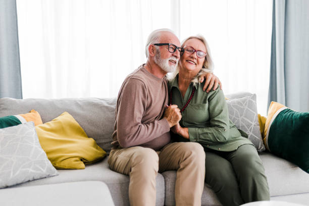 istock Old senior retired couple enjoy talking conversation together on sofa with happiness laugh smile and joyful at home 1456018792