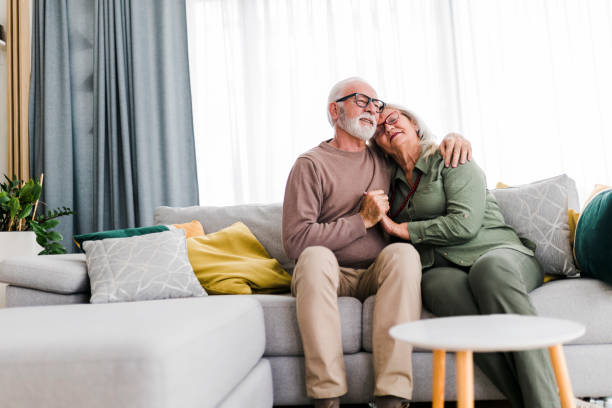 istock Old senior retired couple enjoy talking conversation together on sofa with happiness laugh smile and joyful at home 1456018800