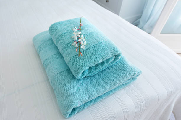 fresh turquoise hotel towels with a decorative flower