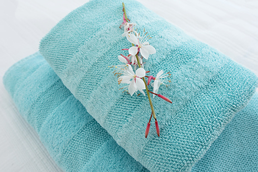 fresh turquoise hotel towels with a decorative flower