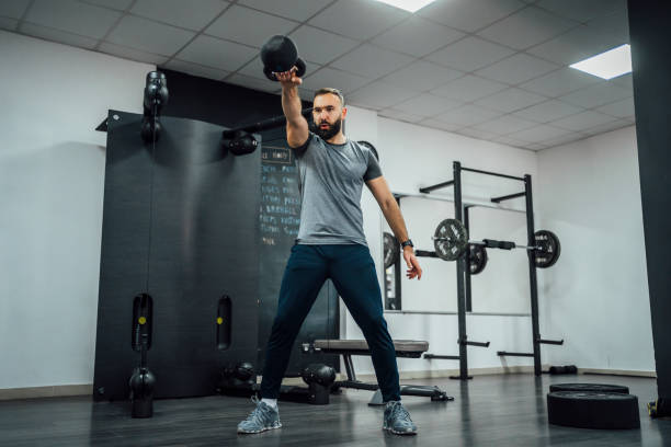 istock Young sporty man exercise with kettlebell 1456019686