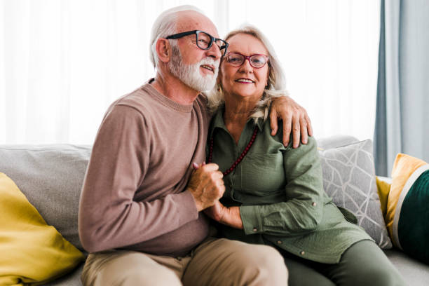 istock Old senior retired couple enjoy talking conversation together on sofa with happiness laugh smile and joyful at home 1456021341