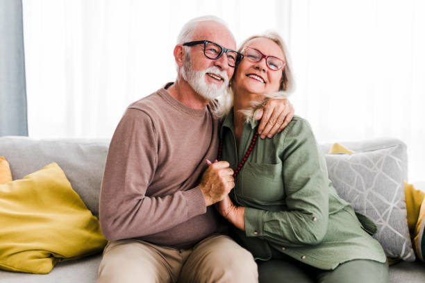 istock Old senior retired couple enjoy talking conversation together on sofa with happiness laugh smile and joyful at home 1456021475