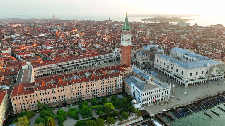 Aerial drone Sunrise scene of iconic and unique Saint Mark's square or Piazza San Marco featuring Doge's Palace, Basilica and Campanile, Venice, Italy,  St Mark's Basilica is the cathedral church of the Roman Catholic Patriarchate of Venice