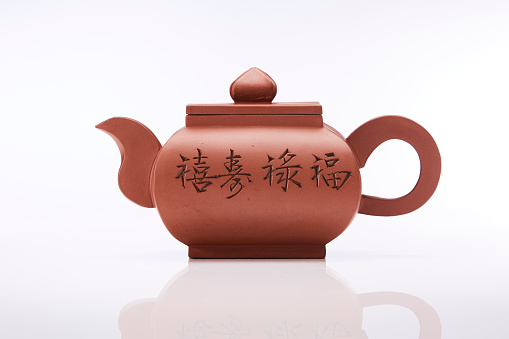 Chinese red teapot isolated on white background, studio shot.