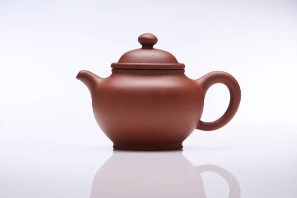 istock Brown clay teapot on white white background, studio shot. 1456021896