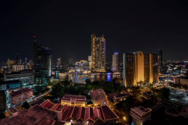istock Modern buildings in the city with water reflection, firework, light show at night time. 1456022533
