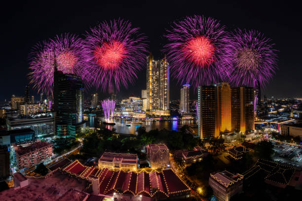 istock Modern buildings in the city with water reflection, firework, light show at night time. 1456022534