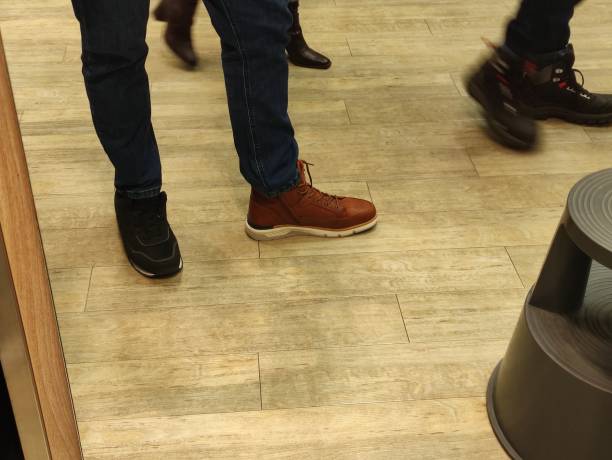 istock Man trying on brown winter boots in a store 1456022726