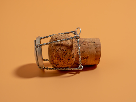 Champagne cork on an orange background. Cork from the bark of a tree. Close-up.