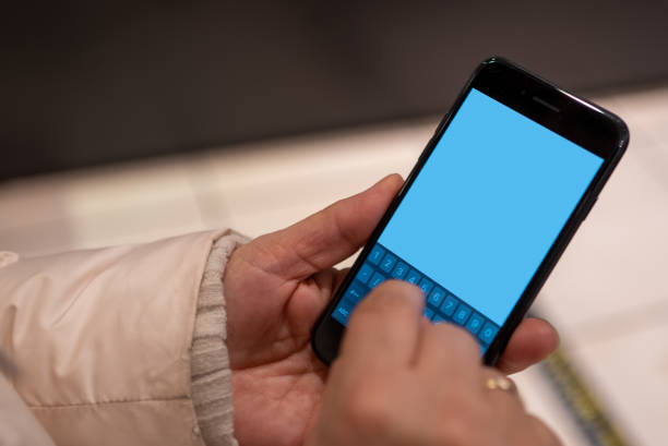 istock Woman uses mobile phone 1456025749