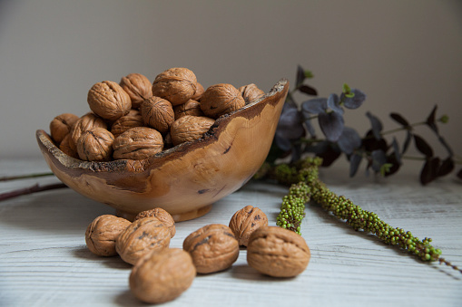 a wooden plate filled with walnuts