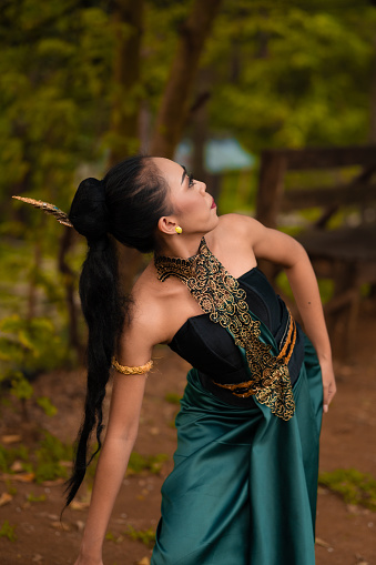 https://media.istockphoto.com/id/1456027530/photo/an-indonesian-woman-poses-with-black-hair-dangling-to-the-ground-while-wearing-a-green-dance.jpg?b=1&s=170667a&w=0&k=20&c=ad7Pd2x09qGhYWk-1kAMAMMr3YHOxRIHwqu9LdYE_gI=