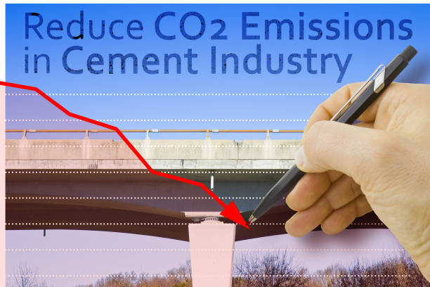 Reduce CO2 production in cement Industry and emissions in atmosphere - low-carbon cement production concept with elevated highway in concrete structure and hand drawing a descending graph about carbon dioxide emissions reducir la producción de co2 en la industria del cemento y las emisiones en la atmósfera: concepto de producción de cemento bajo en carbono con carretera elevada en estructura de hormigón y dibujo manual de un gráfico descendente sobre las emisiones d