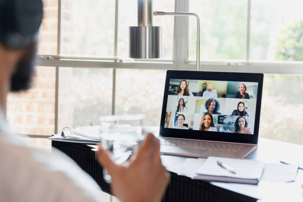 istock Over-the-shoulder view unrecognizable man using laptop for virtual meeting 1456028748