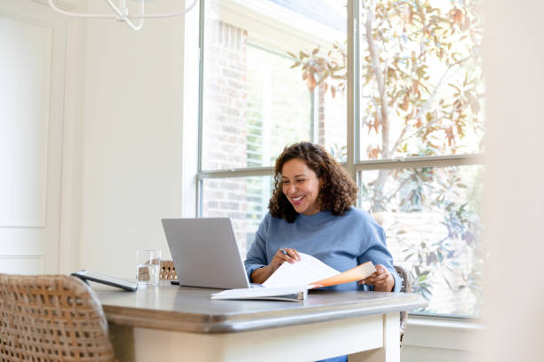 istock Mature female financial advisor smiles at client during virtual meeting 1456028817