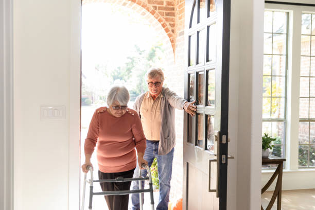 istock Senior husband holds front door open for senior wife 1456028888